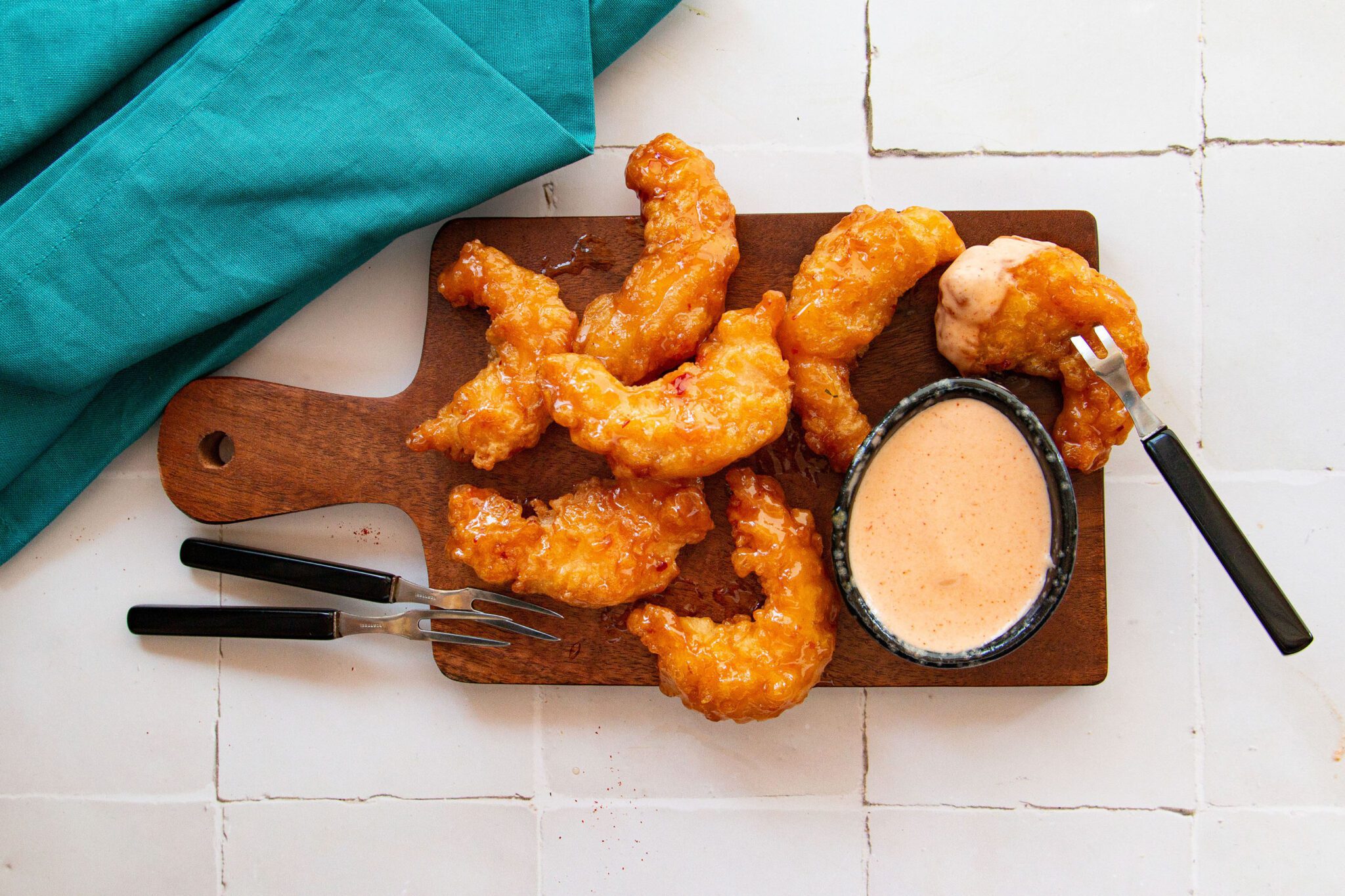 Yum Yum Sauce with shrimp on a cutting board