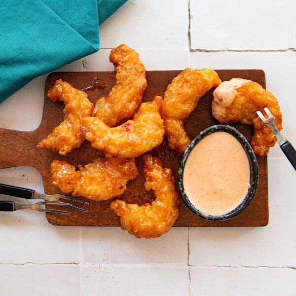 Yum Yum Sauce with shrimp on a cutting board