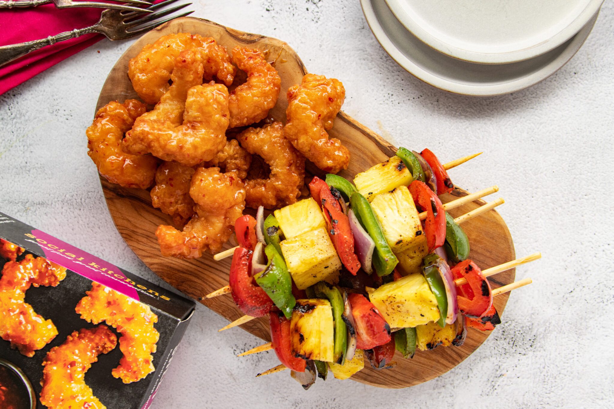 Pineapple Veggie Kabobs with Sweet & Spicy Shrimp on a wooden serving board