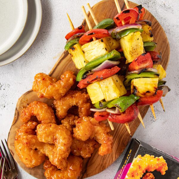 Pineapple Veggie Kabobs with Sweet & Spicy Shrimp on a wooden serving board