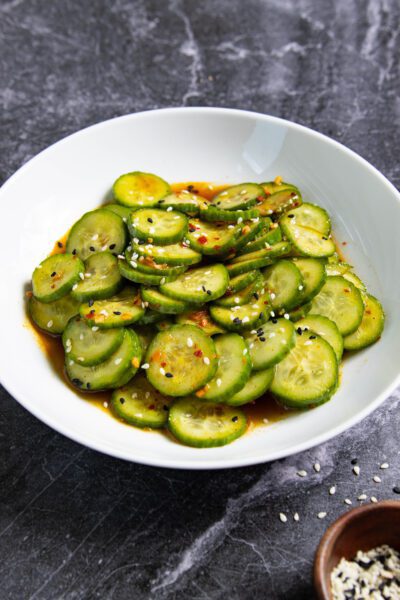 Spicy Cucumber Salad in a white bowl